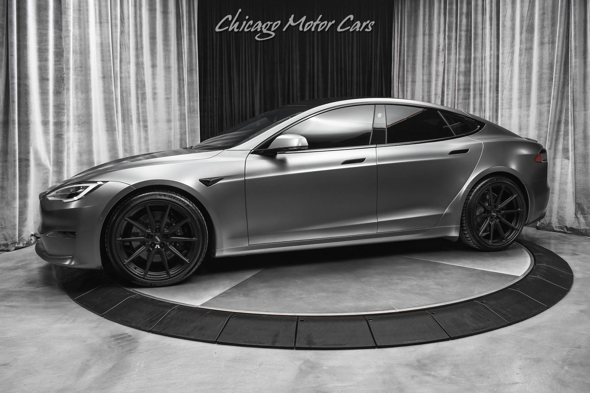 https://www.chicagomotorcars.com/imagetag/10305/main/l/Used-2021-Tesla-Model-S-Plaid-Sedan-Autopilot-Matte-Gray-Wrap-Vossen-Hybrid-Forged-Wheels.jpg